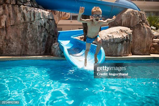 little boy enjoying water slide in waterpark - vattenrutschbana rutschkana bildbanksfoton och bilder