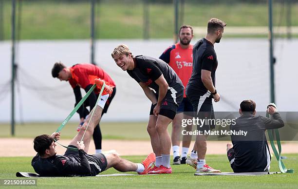 Rasmus Hojlund of Manchester United interacts with teammate Harry Maguire during a training session at Carrington Training Ground on May 14, 2025 in...