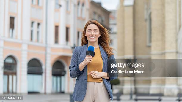 fröhlicher reporter teilt wichtige neuigkeiten in der innenstadt mit - nachrichtensprecher stock-fotos und bilder