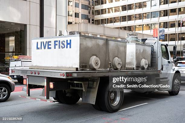 Fish Lorry Flatbed truck carrying tanks labeled LIVE FISH on downtown street ...
