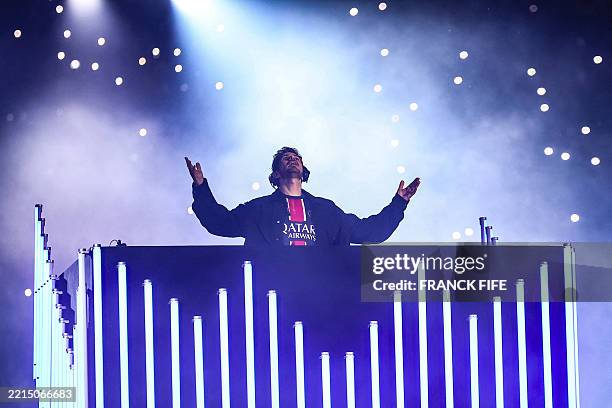 French DJ Michael Canitrot performs in a post-match show after PSG won the match and to celebrate their championship title following the French L1...