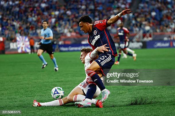 Max Floriani of San Jose Earthquakes tries to hold off Peyton Miller of New England Revolution during the first half at Gillette Stadium on May 17,...