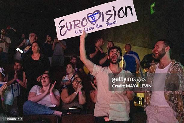 People react as they watch the votes being counted during the 2025 Eurovision Song Contest being screened at a community center in Tel Aviv, Israel,...