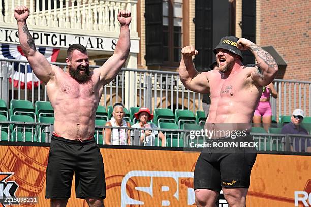 Pavlo Kordiyaka of the Ukraine jokingly admires the abs of Luke Stoltman of Great Britain celebrate after the Natural Stone Medley during the...