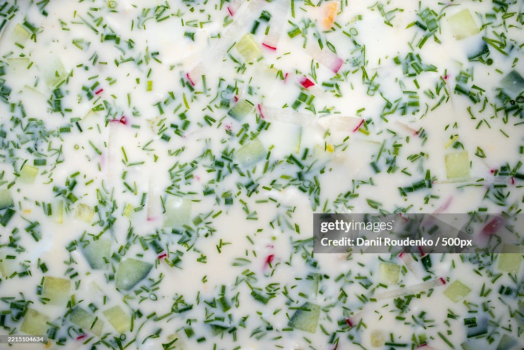 Chilled Russian okroshka featuring kvass,Kefir,Diced cucumbers,Radishes,Garnished with fragrant