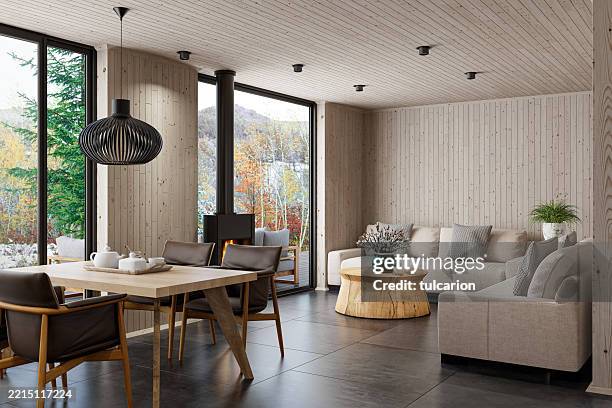 salon scandinave avec canapés, cheminée et accents de bois naturel - panneau en bois photos et images de collection