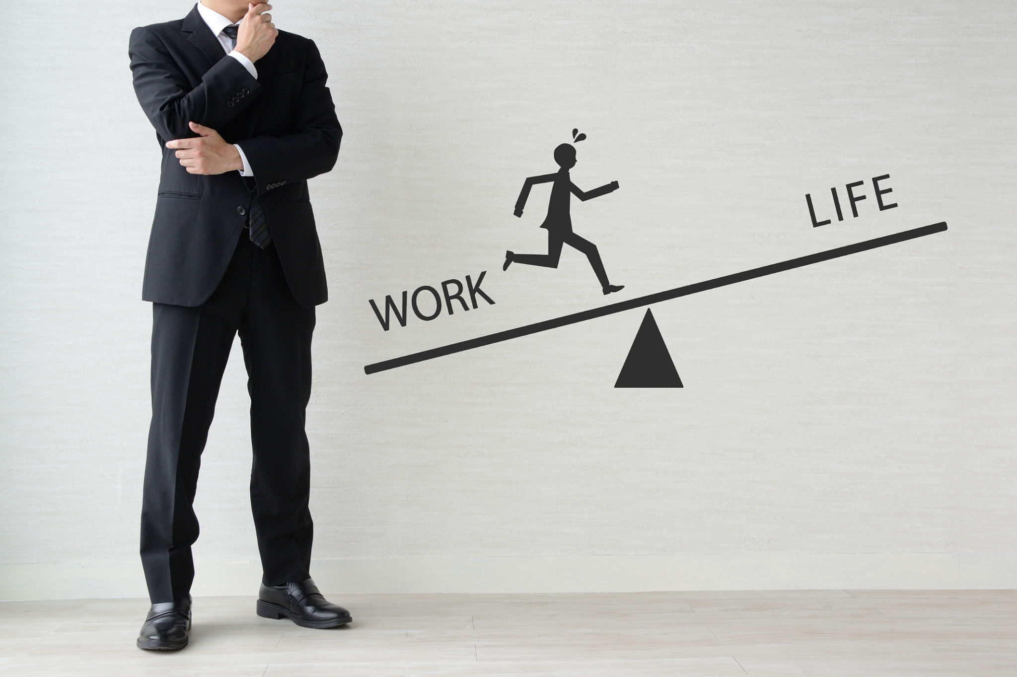 Businessman thinking about work-life balance leaning towards work Businessman thinking about work-life balance leaning towards work
