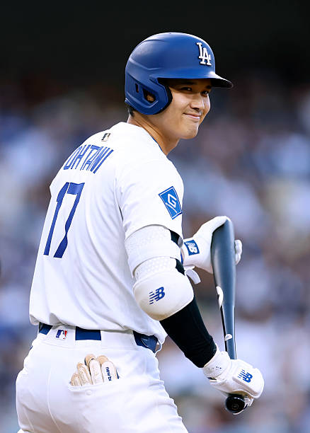 Shohei Ohtani of the Los Angeles Dodgers reacts as he comes to the plate to lead off the game against the Athletics during the first inning at Dodger...