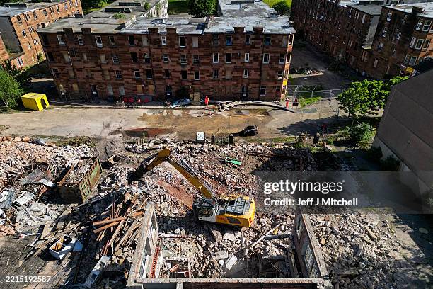 An aerial view of workers using a bulldozer continue the demolition of Clune Park housing estate on May 15, 2025 in Port Glasgow, Renfrewshire....