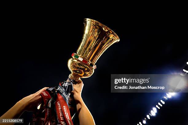 The trophy is seen as players celebrate following the 1-0 victory in the Coppa Italia Final match between AC Milan and Bologna FC at Stadio Olimpico...