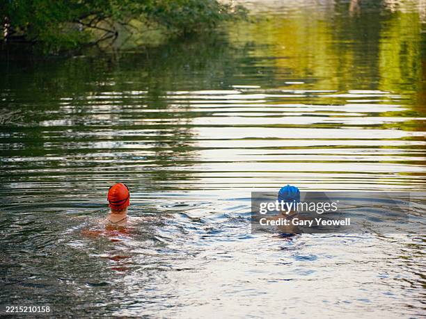 two female open water wild swimmers - woman swimming uk stock pictures, royalty-free photos & images