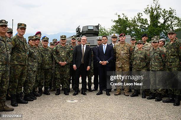 Britain's Prime Minister Keir Starmer poses with British and Albanian troops after speaking to them about their involvement with training Ukarinian...
