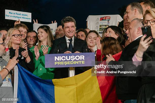 Presidential candidate Nicusor Dan greets supporters after the first exit poll results on the day of the presidential election on May 18, 2025 in...