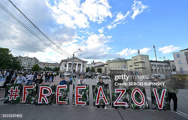 Relatives and friends hold a placard during a rally marking the third anniversary of the capture of Azov Brigade fighters in Mariupol and to call to...