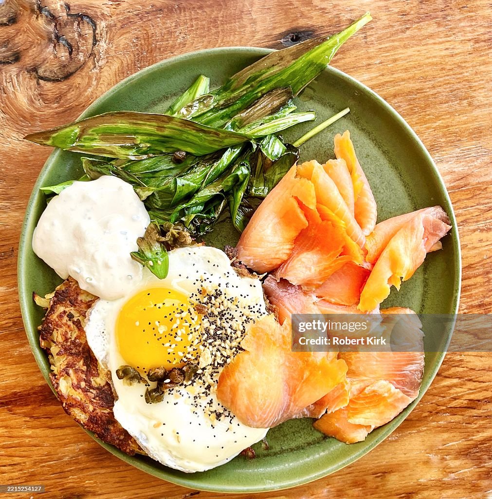 Potato latkes with sunny side up egg, ramps, smoke salmon and sour cream
