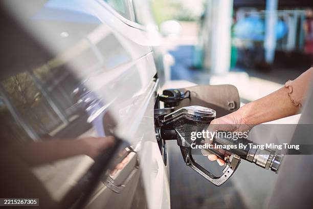 filling up diesel fuel at a gas station - energy crisis stock pictures, royalty-free photos & images