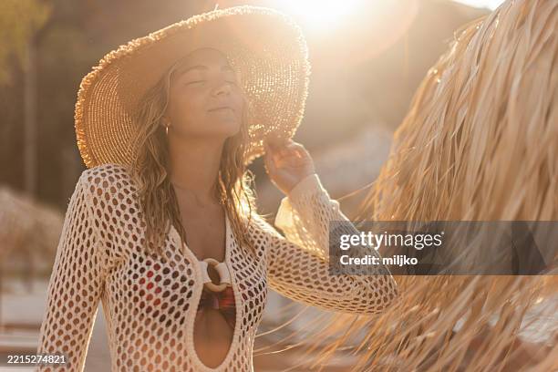 portrait of amazing young woman enjoying alone on beach - white dress stock pictures, royalty-free photos & images