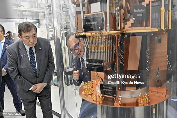 Japanese Prime Minister Shigeru Ishiba is briefed about studies using quantum computers during a visit to the Global Research and Development Center...