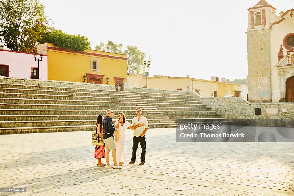 Extreme wide shot mature tourists exploring old town during vacation