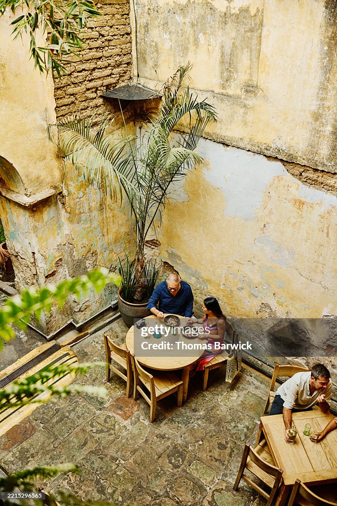 Extreme wide overhead shot senior couple eating breakfast at cafe