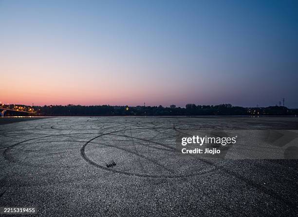 empty road covered with tire marks - strada deserta foto e immagini stock