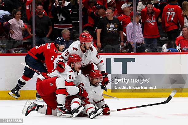 Seth Jarvis of the Carolina Hurricanes celebrates with teammates after scoring an empty net goal against the Washington Capitals during the third...