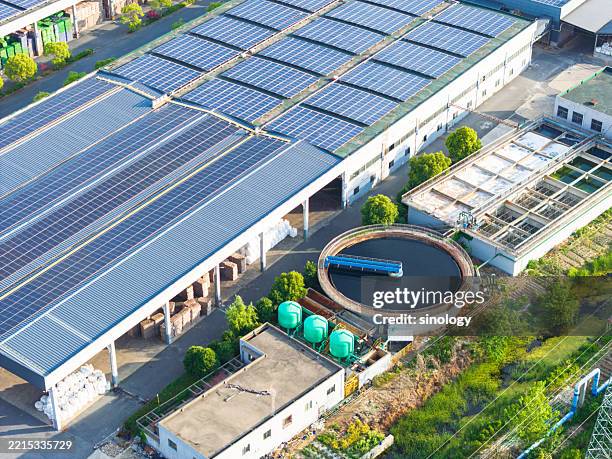 solar panels with wastewater treatment plants in city - wasserpumpanlage stock-fotos und bilder