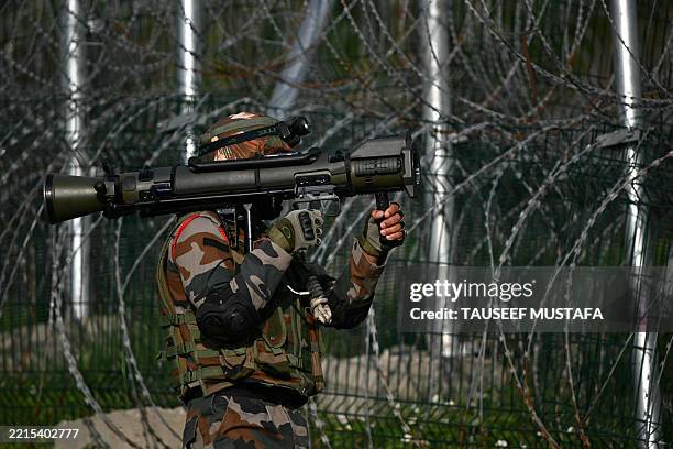 An Indian army soldier carrying a rocket launcher is pictured near the Line of Control in India's Kashmir region on May 19, 2025.