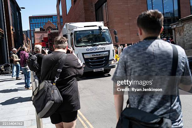Photographers take pictures of a van suspected to be carrying American musician Chris Brown following a hearing where he was remanded in custody on...