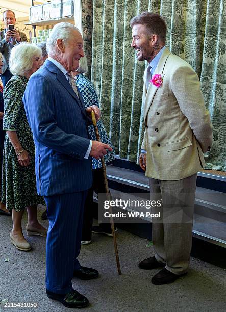 David Beckham wearing a David Austin Roses "King's Rose" speaks with King Charles III, patron of the Royal Horticultural Society during a visit to...