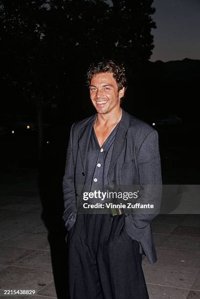American actor Jason Gedrick, wearing a dark grey pinstripe blazer over a grey open-collar shirt, attends the ABC Summer TCA Press Tour at the...