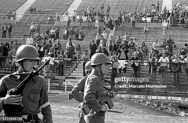 Soldiers guard prisoners held at the National Stadium after the military coup on September 21, 1973.