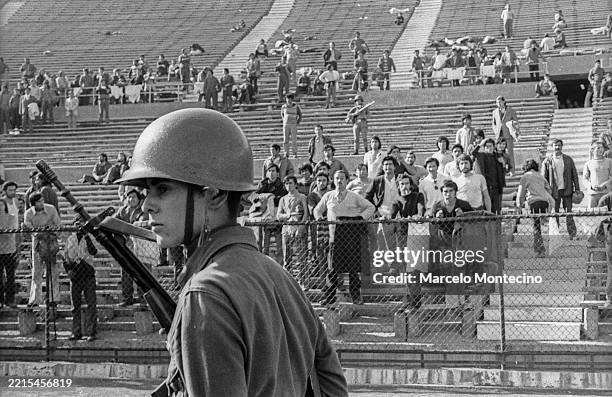 Soldiers guard prisoners held at the National Stadium after the military coup on September 21, 1973.
