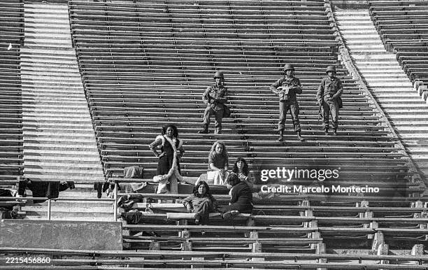 Soldiers guard prisoners held at the National Stadium after the military coup on September 21, 1973.