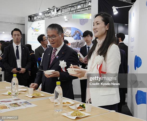 Turin Olympics figure skating gold medalist Shizuka Arakawa pitches fishery foods at a just-opened exhibition at the World Exposition in Osaka on May...