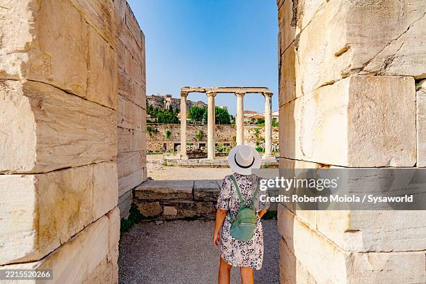 woman visiting the library of hadrian, athens - ancient greece stock pictures, royalty-free photos & images