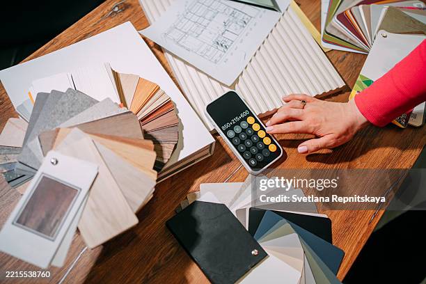 interior designer calculating costs using calculator and samples palettes - foundation swatch stock pictures, royalty-free photos & images