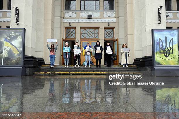 Despite the rain, activists with banners urge to stop and observe fallen Ukrainian soldiers with a minute of silence during a rally near the Odesa...