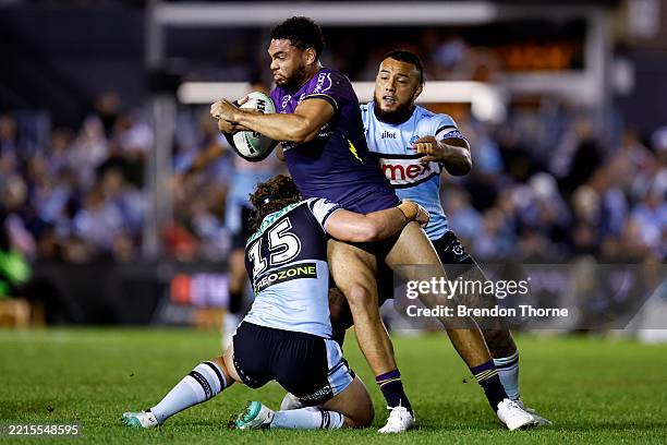 Xavier Coates of the Storm is tackled by the Sharks defence during the round eleven NRL match between Sharks and Storm at Sharks Stadium, on May 17...
