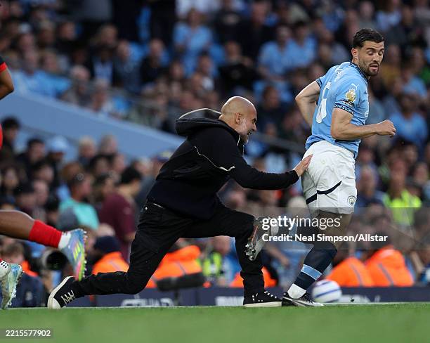Pep Guardiola, Manager of Manchester City and Mateo Kovacic of Manchester City on the side line during the Premier League match between Manchester...