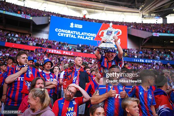 Young Crystal Palace fan holds up a tinfoil FA Cup following the teams victory after the Emirates FA Cup Final match between Crystal Palace and...