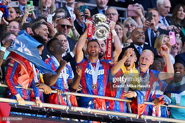 Joel Ward of Crystal Palace the FA Cup trophy after their team's victory in the Emirates FA Cup Final match between Crystal Palace and Manchester...