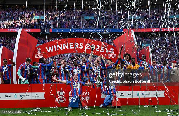 Marc Guehi and Joel Ward of Crystal Palace lift the FA Cup trophy after his team's victory in the Emirates FA Cup Final match between Crystal Palace...