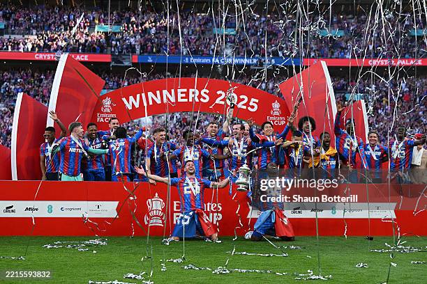 Marc Guehi and Joel Ward of Crystal Palace lift the FA Cup trophy after their team's victory in the Emirates FA Cup Final match between Crystal...