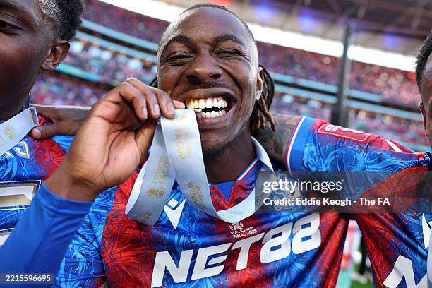 Eberechi Eze of Crystal Palace bites his winners medal after the Emirates FA Cup Final match between Crystal Palace and Manchester City at Wembley...