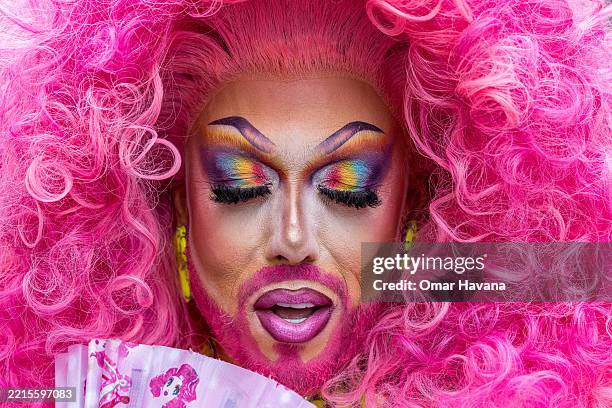 Participant shows their eyelids painted with the rainbow flag while posing for a photo during the annual Pride Parade celebrations in the streets of...