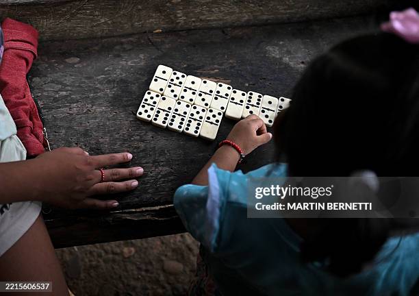 Two girls play dominoes in the small town of Boca de Uracillo, in Cocle province, Panama, on May 14, 2025. The Panama Canal authorities are pushing...