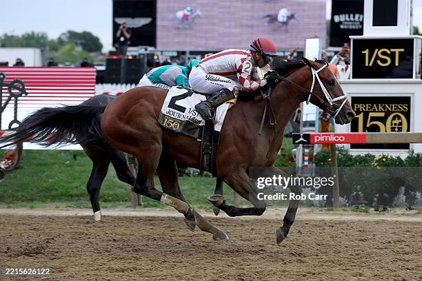 Jockey Umberto Rispoli crosses the finish line on Journalism to win the 150th Preakness Stakes at Pimlico Race Course on May 17, 2025 in Baltimore,...