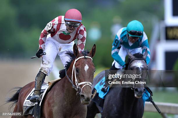 Jockey Umberto Rispoli celebrates aboard Journalism ahead of jockey Luis Saez and Gosger after winning the 150th Preakness Stakes the 150th Preakness...