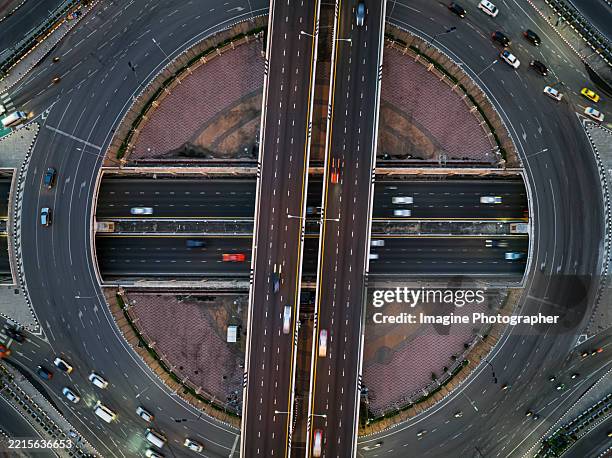 aerial top view, highway road roundabout intersection or circle for transportation that facilitates the travel of car users on the road transportation or futuristic concept. - infinite loop (street) fotografías e imágenes de stock